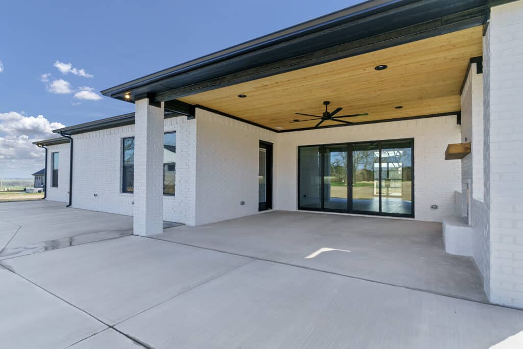 Covered back patio with stained wood ceiling on a custom home in Godley, TX